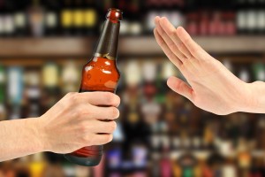 beer is being poured into the mouth from bottle