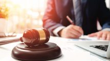 person with gavel and computer